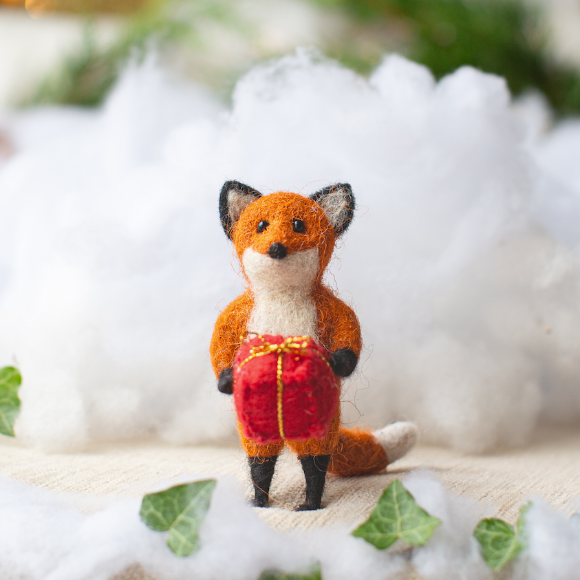 Rusty Fox Holding a Present