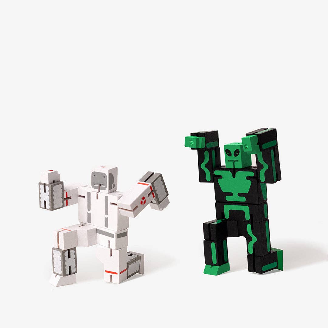 Two robot toy figures, one green and black, the other white and gray, on a white background.