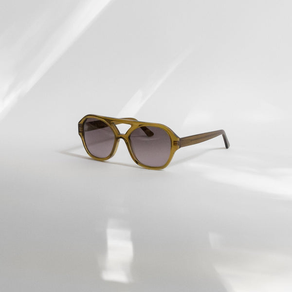 a picture of the chiyo avocado sunglasses at an angle, against a white backdrop