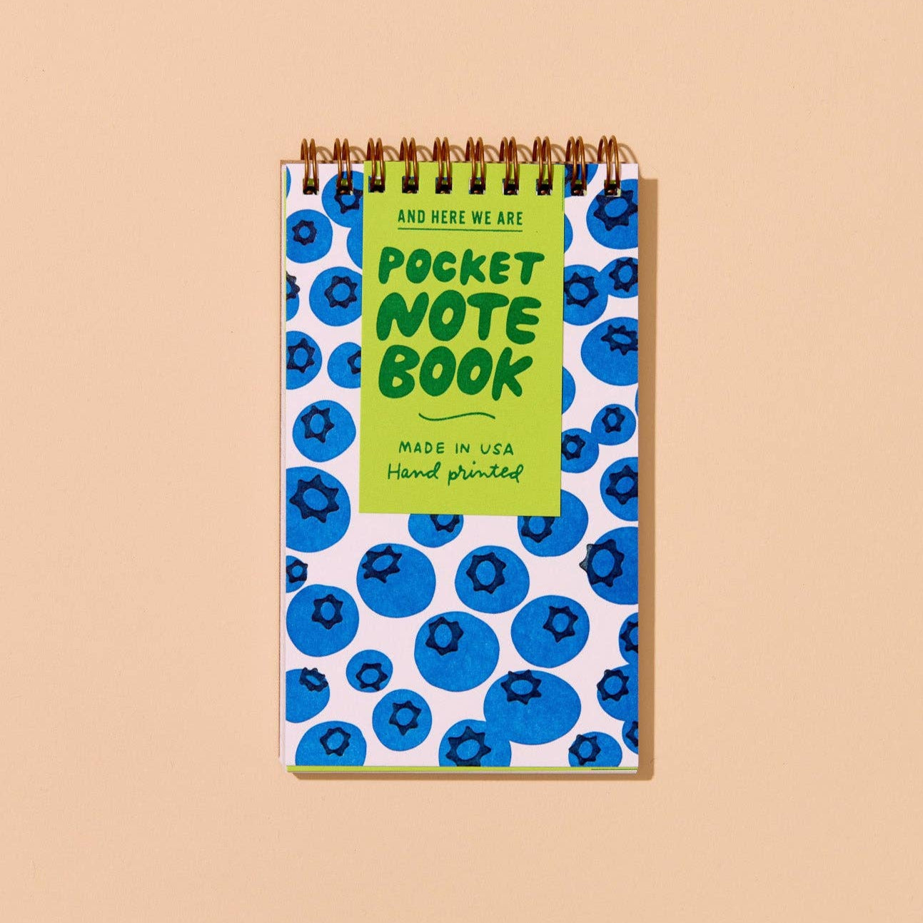 Pocket notebook with blueberry pattern on a beige background