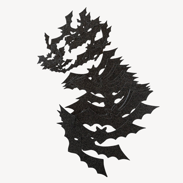 A pile of black bat cutouts against a white background.