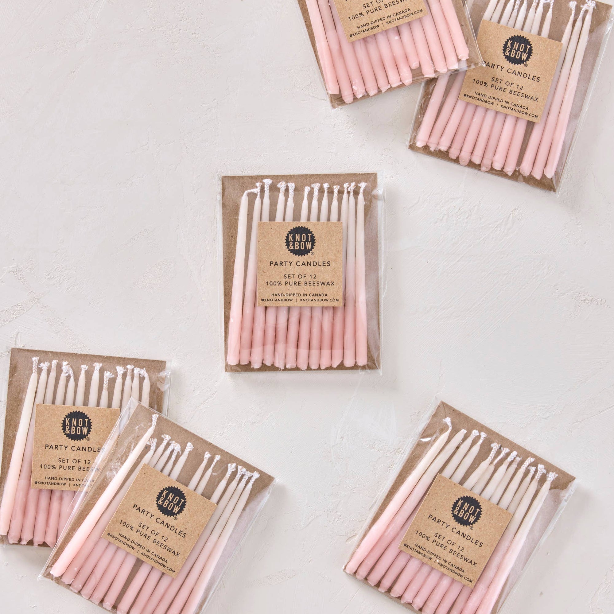 Packages of pink candles on a white background