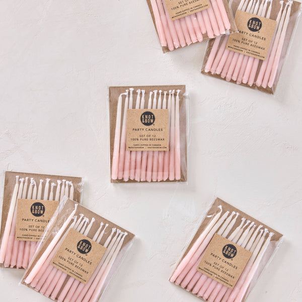 Packages of pink candles on a white background