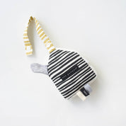 Black and white striped baby toy with yellow accents on a light gray background