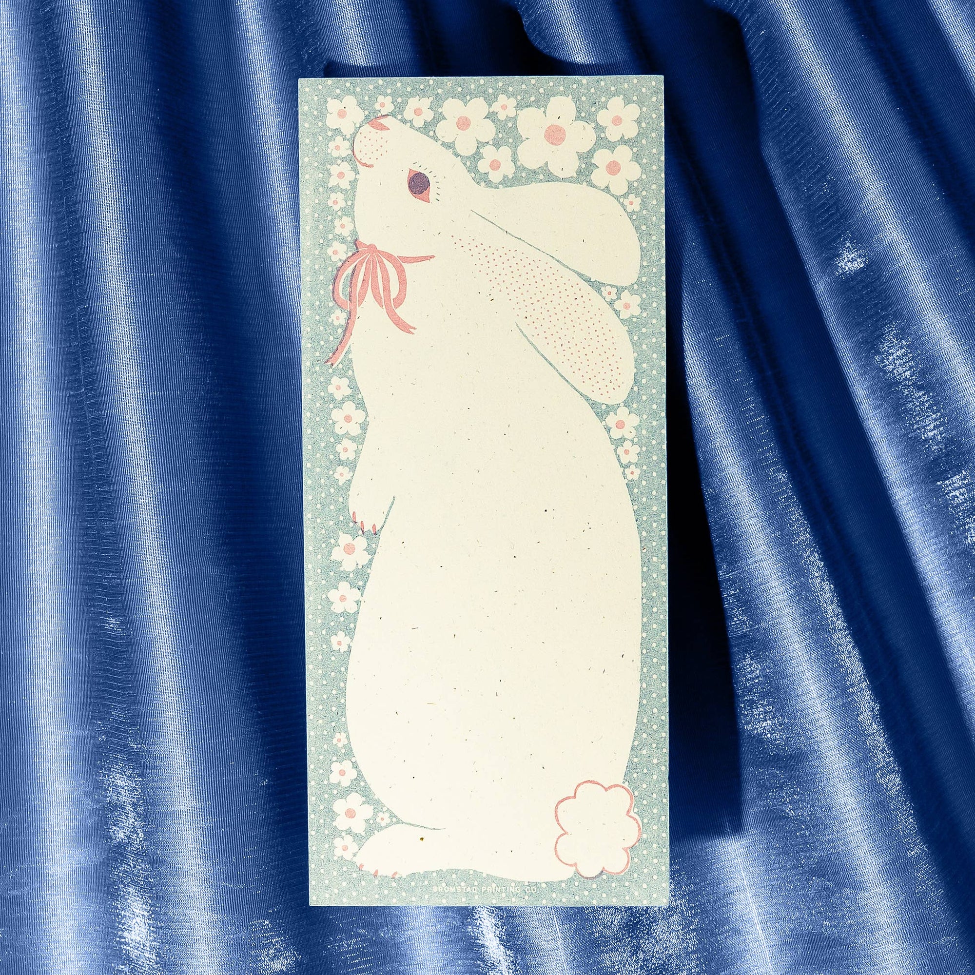Notepad with a white rabbit design on a blue fabric background