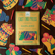 Colorful paper garland kit with packaging on a wooden surface