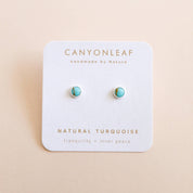 Turquoise earrings on a Canyonleaf branded card with a beige background