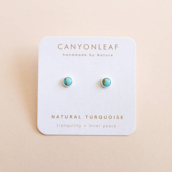 Turquoise earrings on a Canyonleaf branded card with a beige background