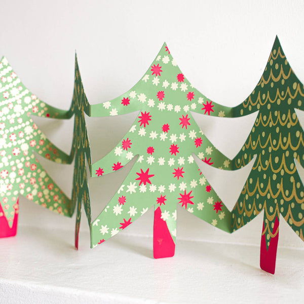 Decorative paper trees with colorful patterns on a white background