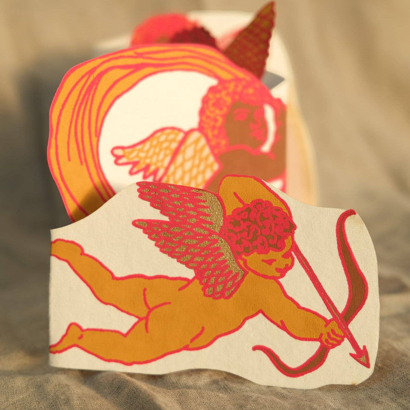 Decorative card with Cupid illustration on a textured surface
