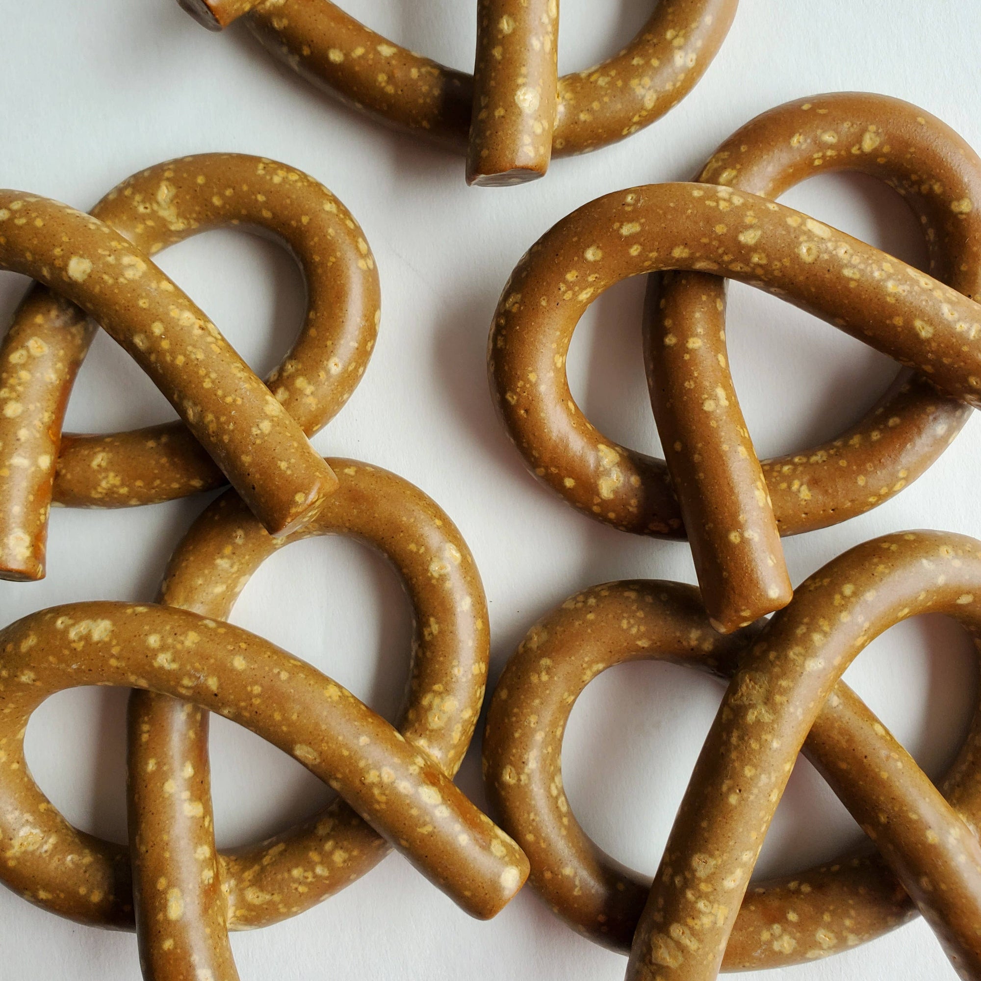 Close-up of clay pretzels on a white background