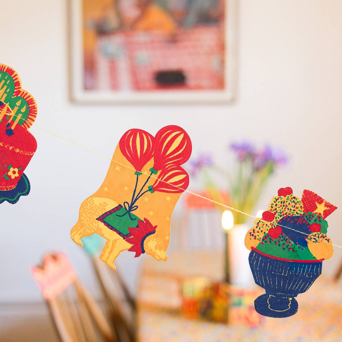 Colorful paper decorations on a wall with a blurred background
