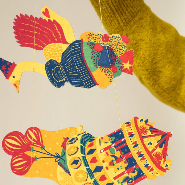 Colorful paper cutout of a traditional instrument on a beige background