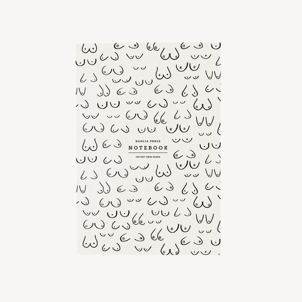Notebook cover with illustrated breast pattern and simple branding on a white background