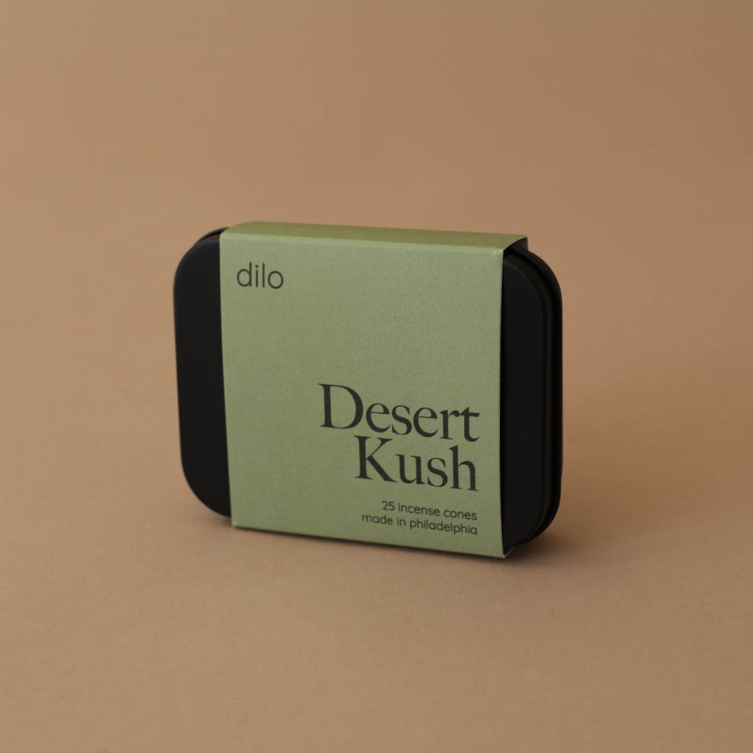 Green and black packaging of 'Desert Kush' by dilo on a brown background
