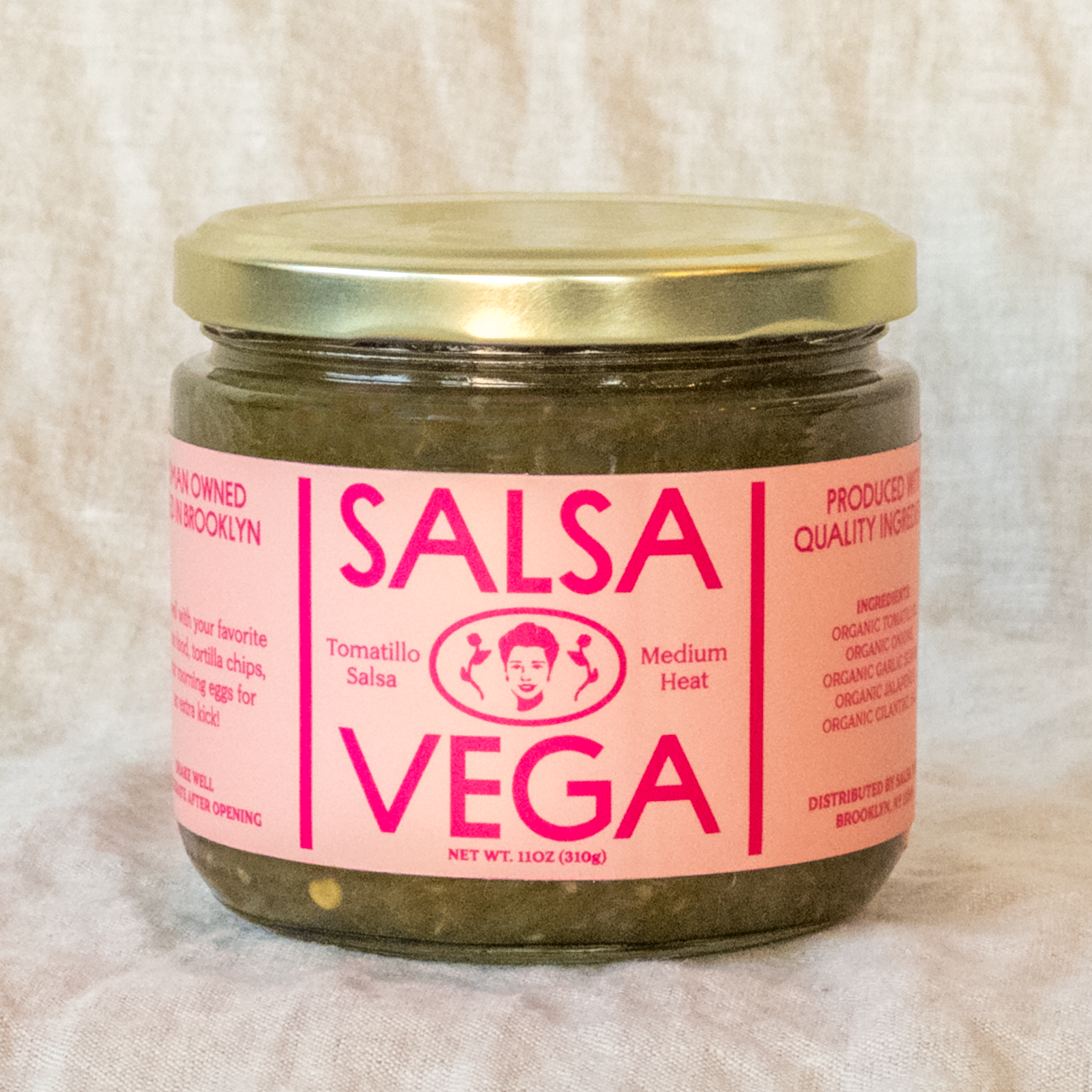 A jar of Salsa Vega Tomatillo Salsa with a pink label on a white background.