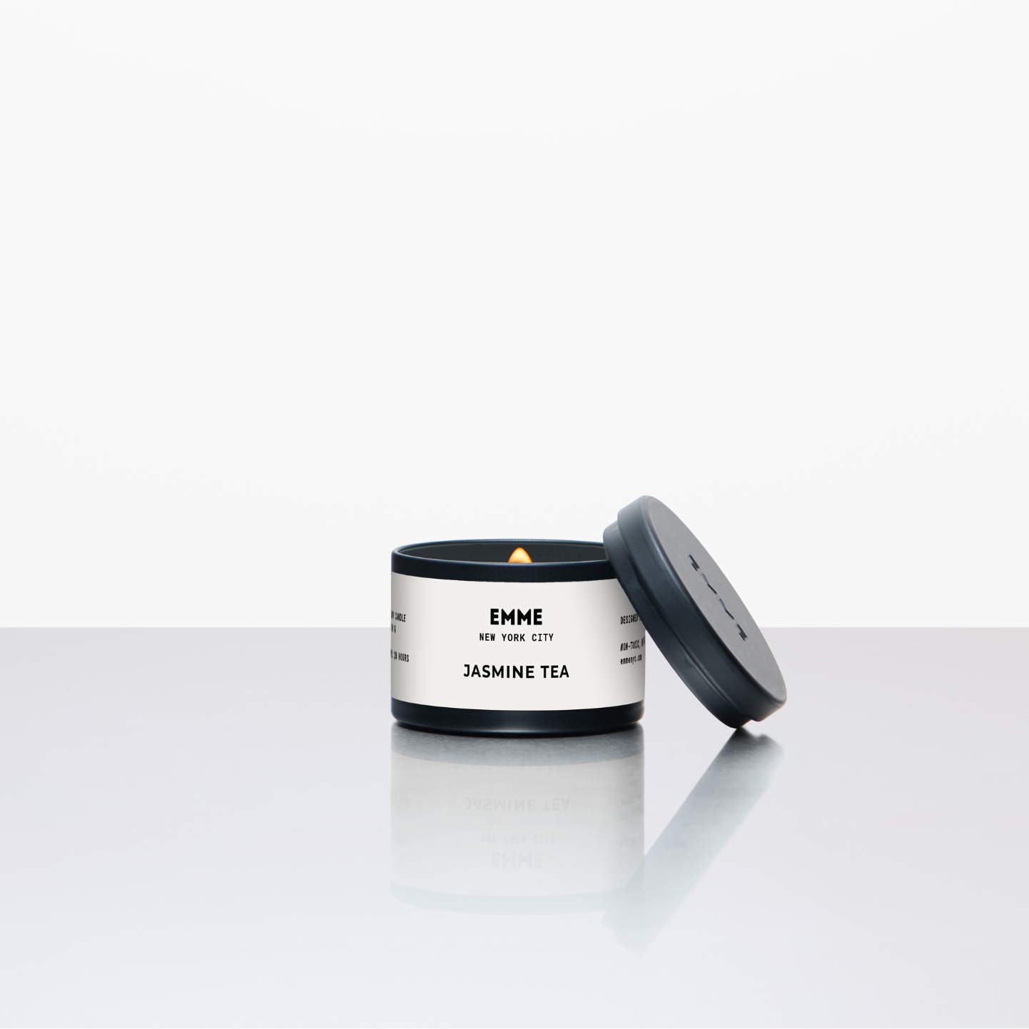Candle with a white label on a light gray background
