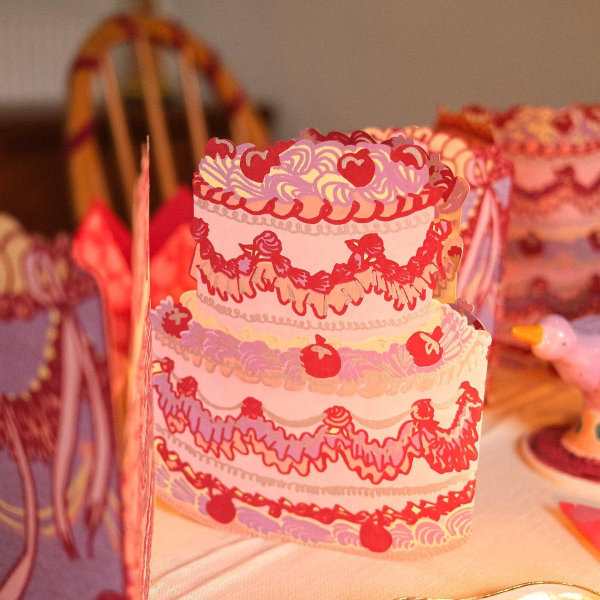 Decorative cake with intricate designs on a table.