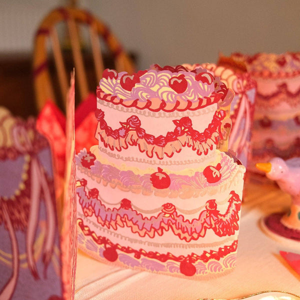 Decorative cake with intricate designs on a table.