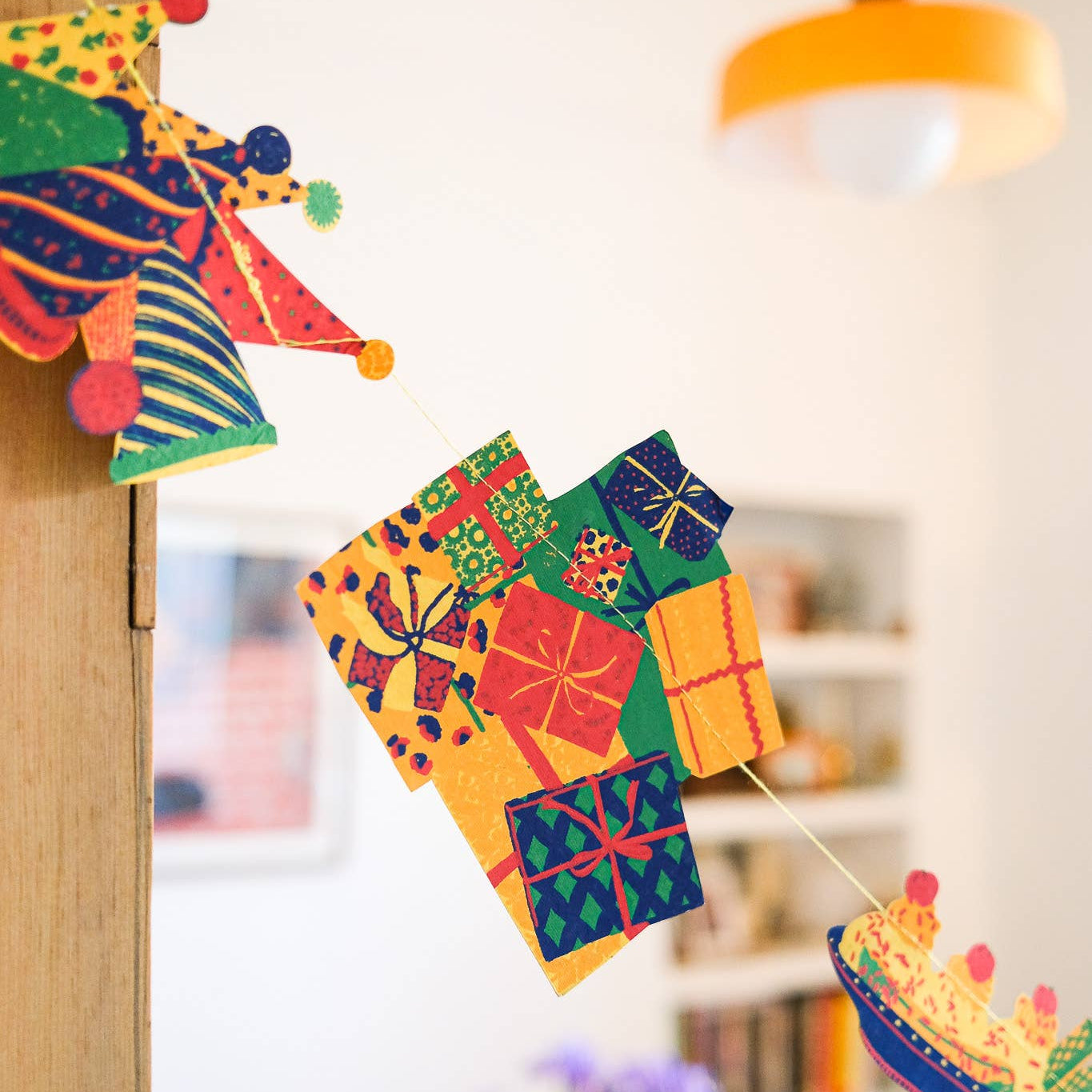 Colorful paper lanterns hanging indoors with a blurred background