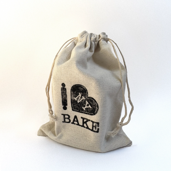 Beige drawstring bag with 'I ❤️ NY BAKE' text on a white background
