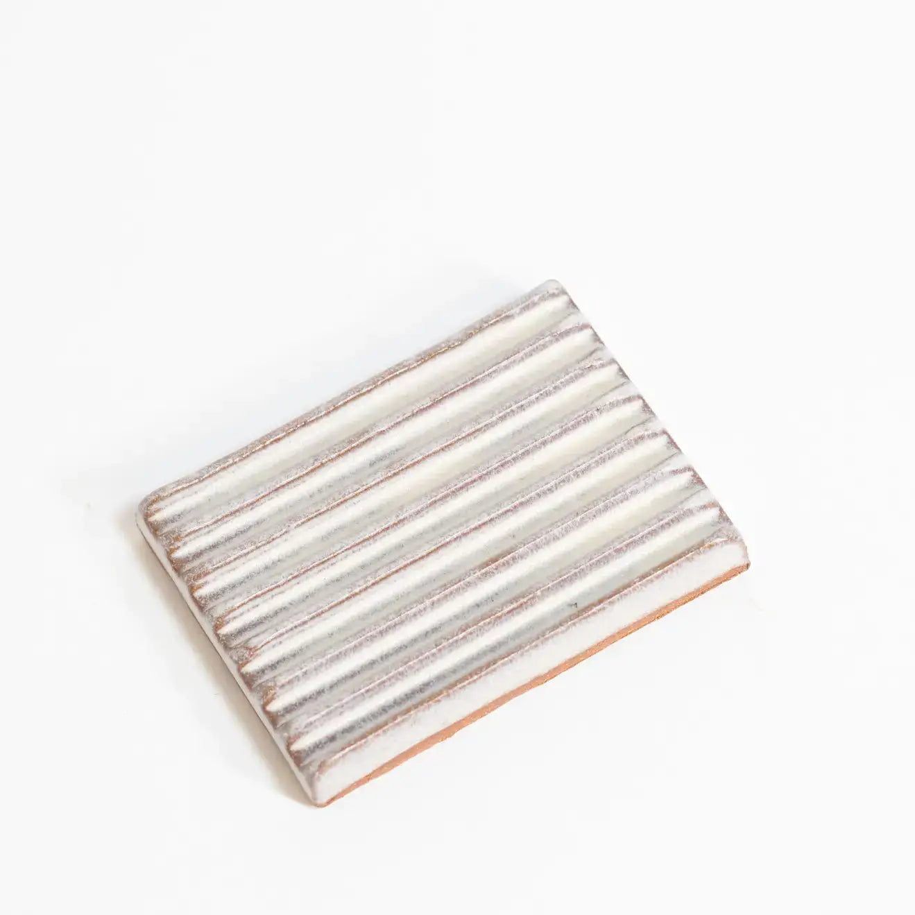 Rectangular ceramic soap dish with striped pattern on a white background