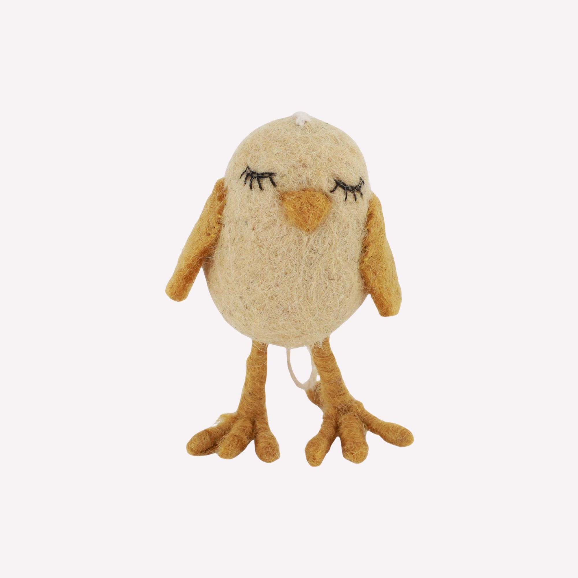 Felt chicken figurine with closed eyes on a white background