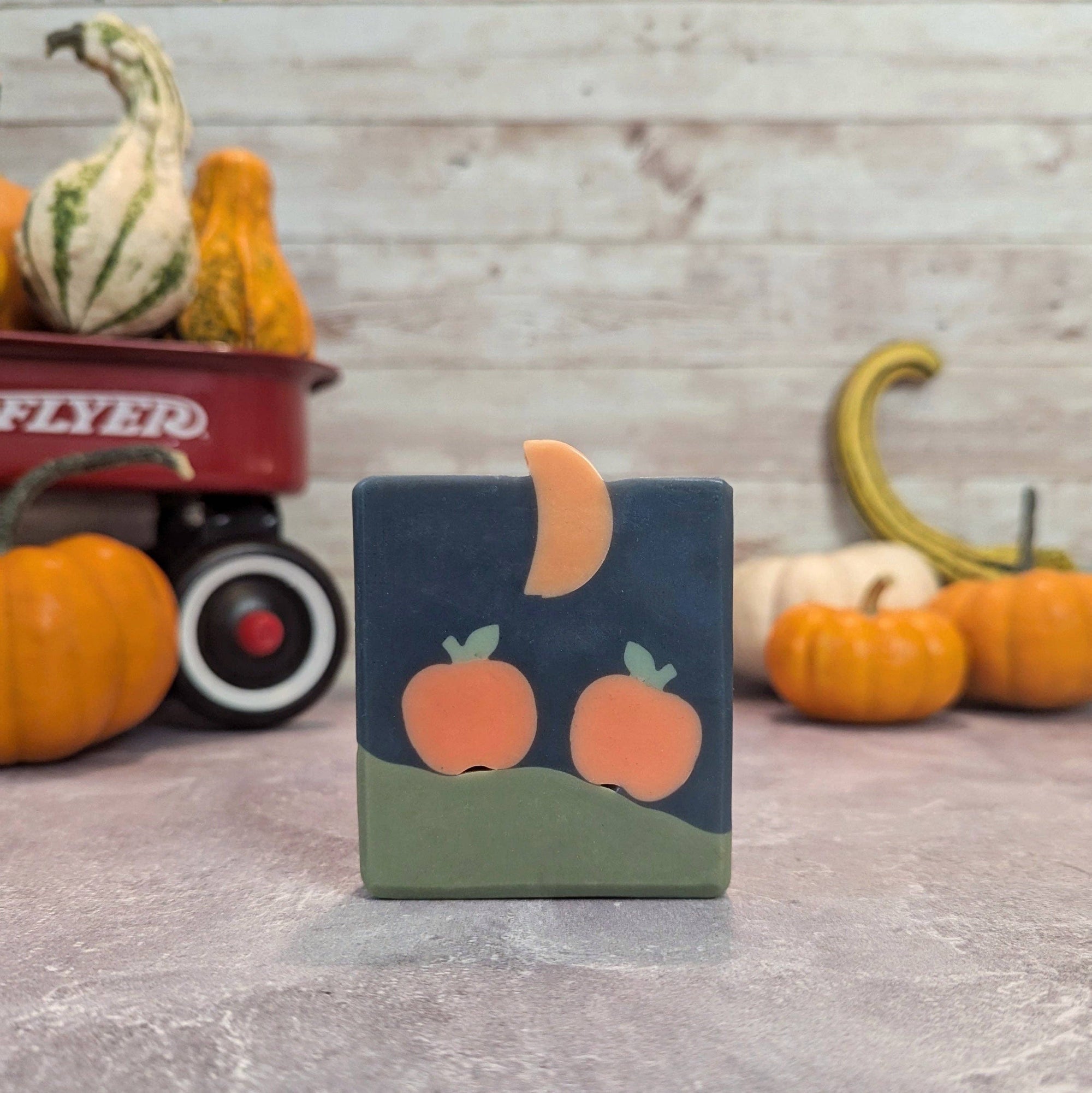 Decorative soap with pumpkin design on a rustic background