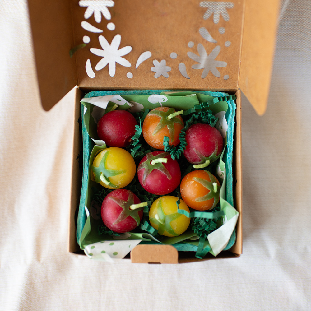 Box of 8 decorative tomato candles with a floral design on the lid