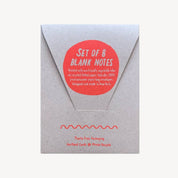 A kraft paper envelope-style package with a red circular sticker reading 'SET OF 8 BLANK NOTES' on a white background.