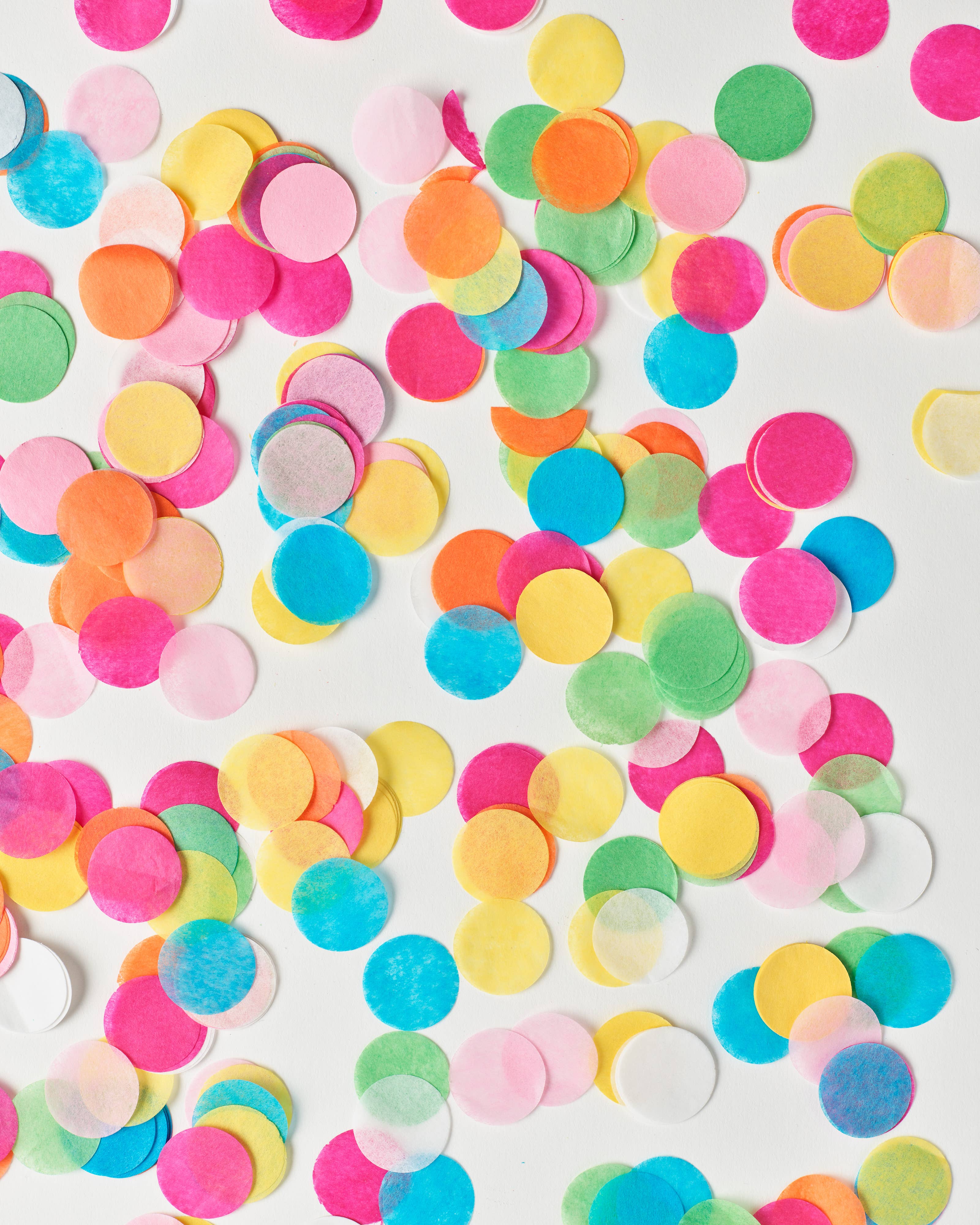 Colorful confetti dots on a white background
