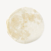Moon-shaped cut out napkin against a white background.