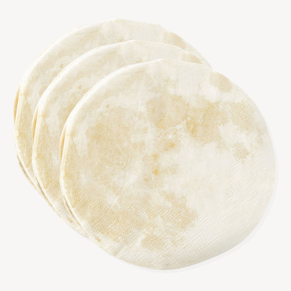 A pile of moon-shaped cut out napkin against a white background.