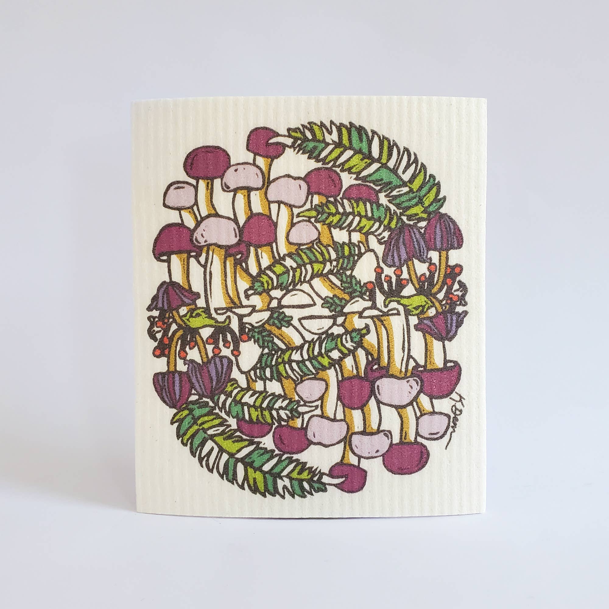 Swedish dishcloth with colorful mushroom design on a white background
