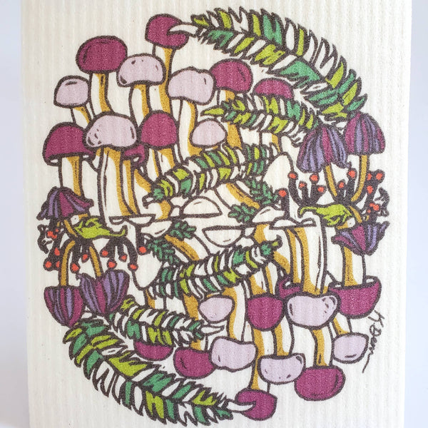 Colorful mushroom and leaf patterned reusable dishcloth on a white background