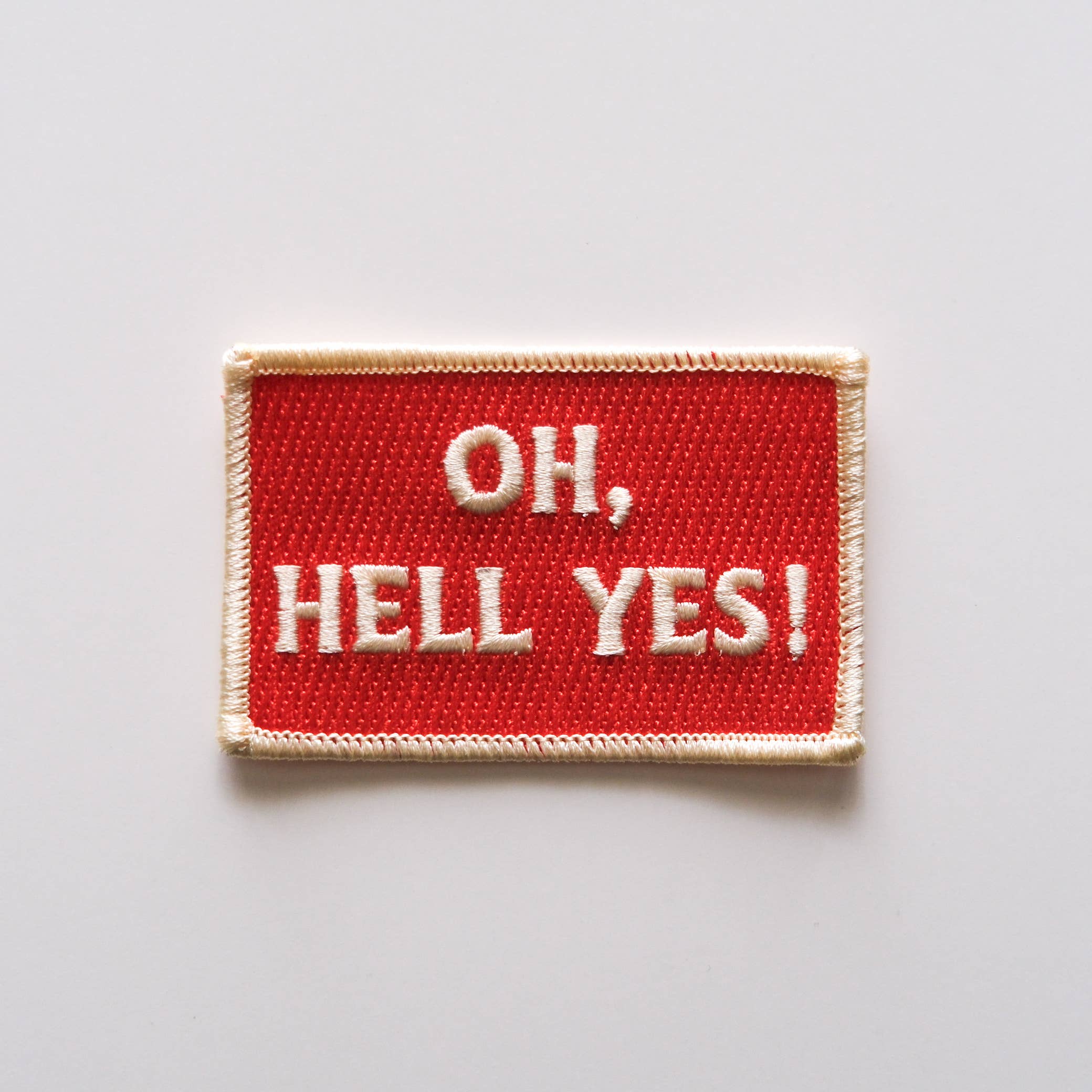 Red patch with 'OH, HELL YES!' text on a light gray background