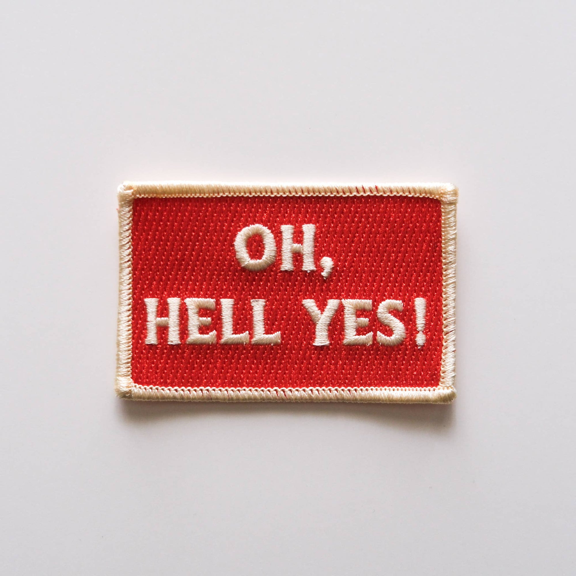 Red patch with 'OH, HELL YES!' text on a light gray background