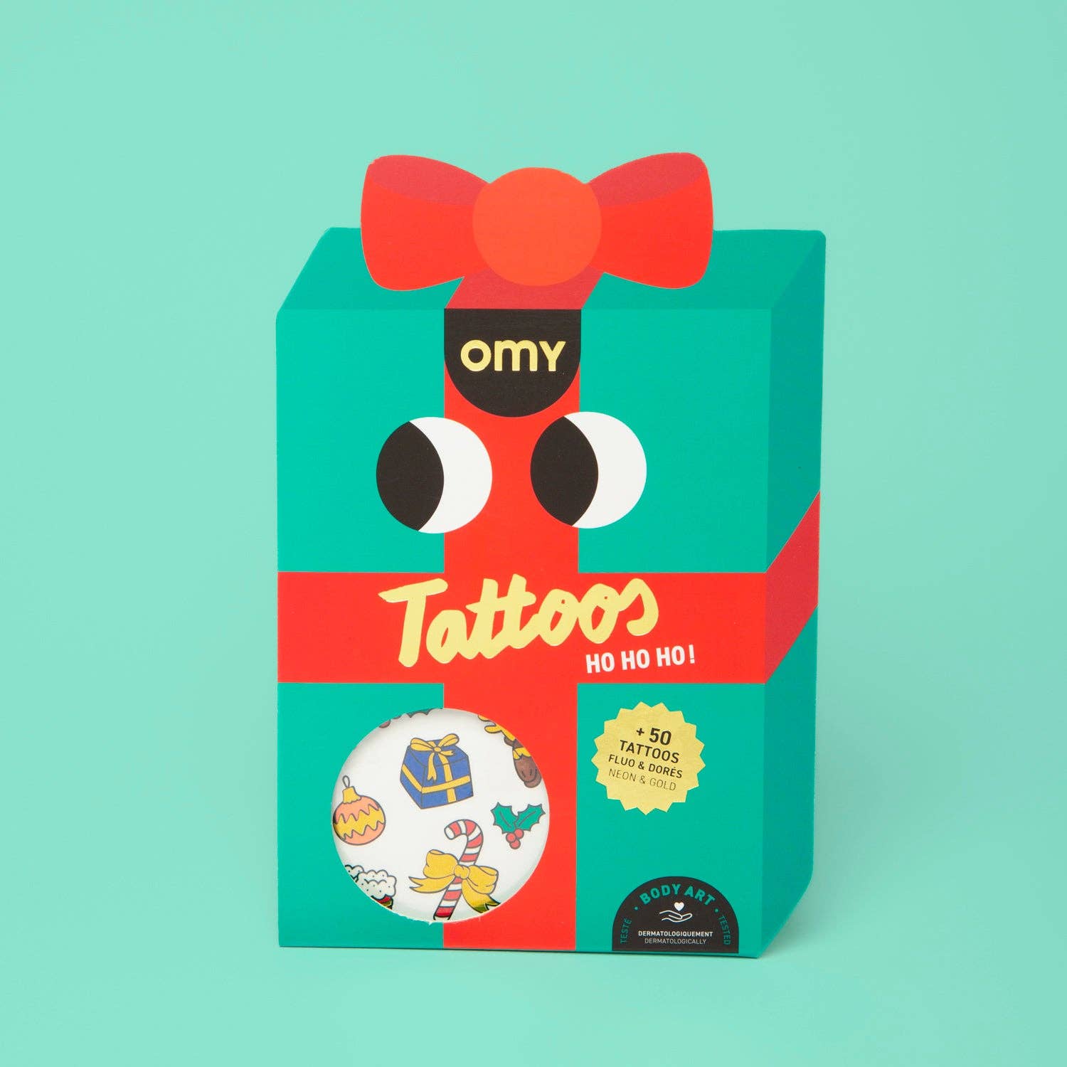 Omy tattoos packaging with a red bow and green background