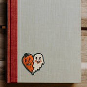 Notebook with Halloween-themed design on a wooden surface