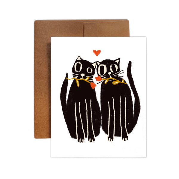 Greeting card with an illustration of two black cats holding hearts, on a white background, with a blank interior for a personal message.