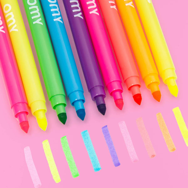 Set of colorful markers with visible brand name on a pink background
