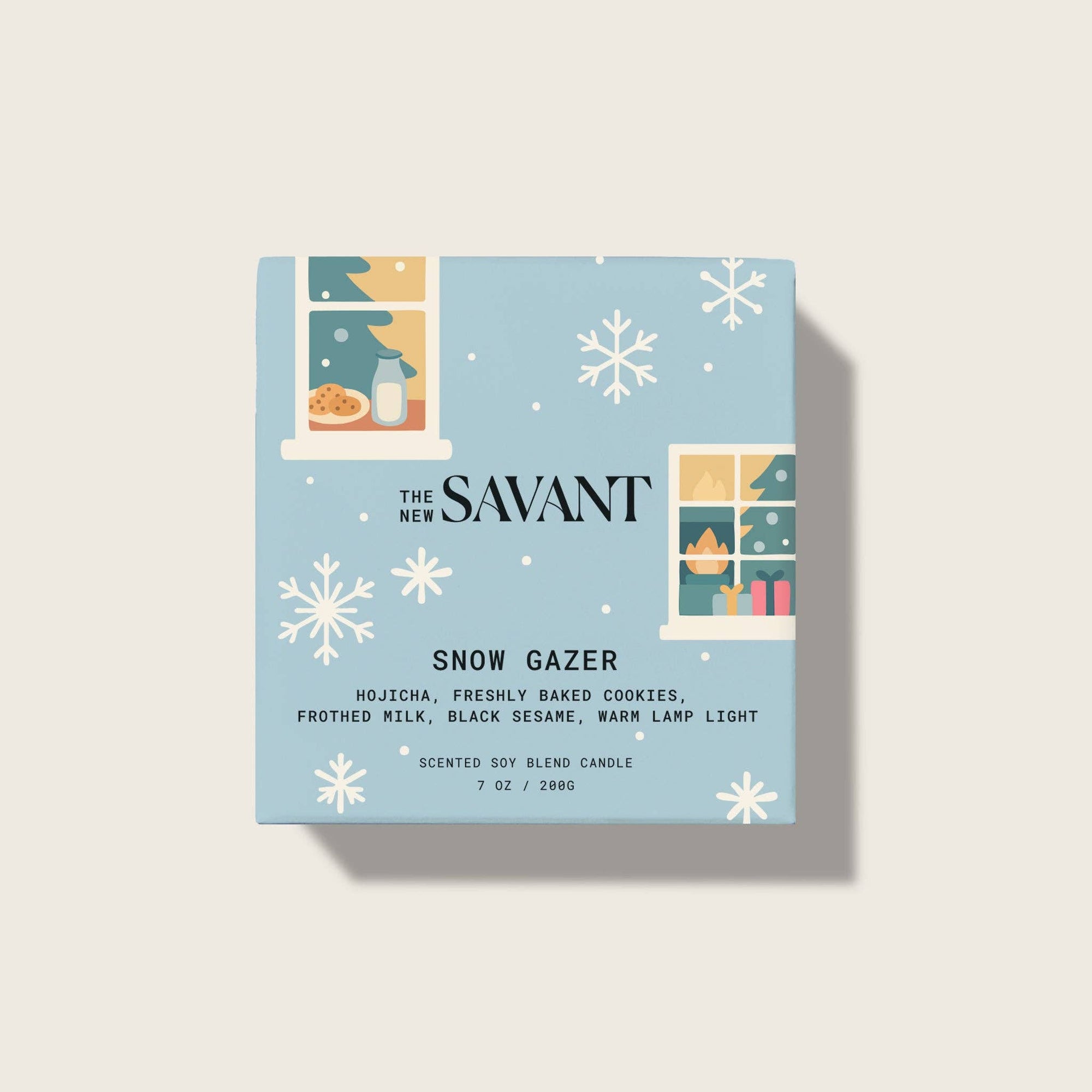 Candle packaging for 'Snow Gazer' by The New Savant on a light blue background with snowflake designs.