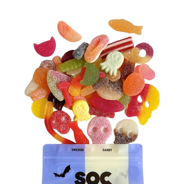 Assorted colorful Swedish gummy candies spilling out of a blue and white bag labeled 'SOC'.