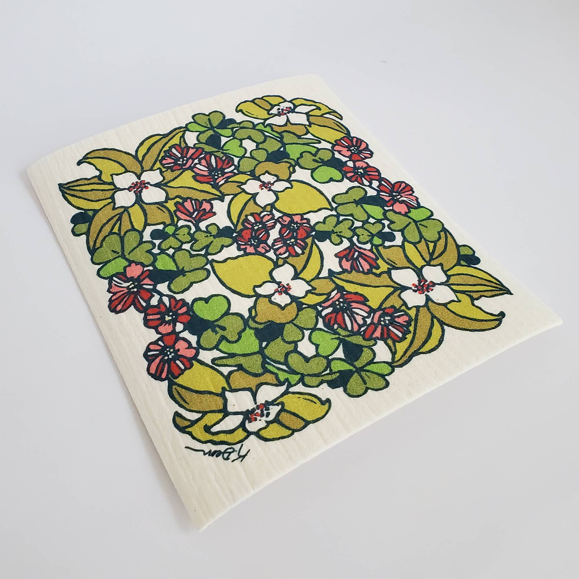 Floral patterned dishcloth on a white background