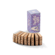 Set of wooden letter and number blocks with a purple packaging box on a white background