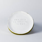 Round white plate with 'You look beautiful today' text on a light gray background
