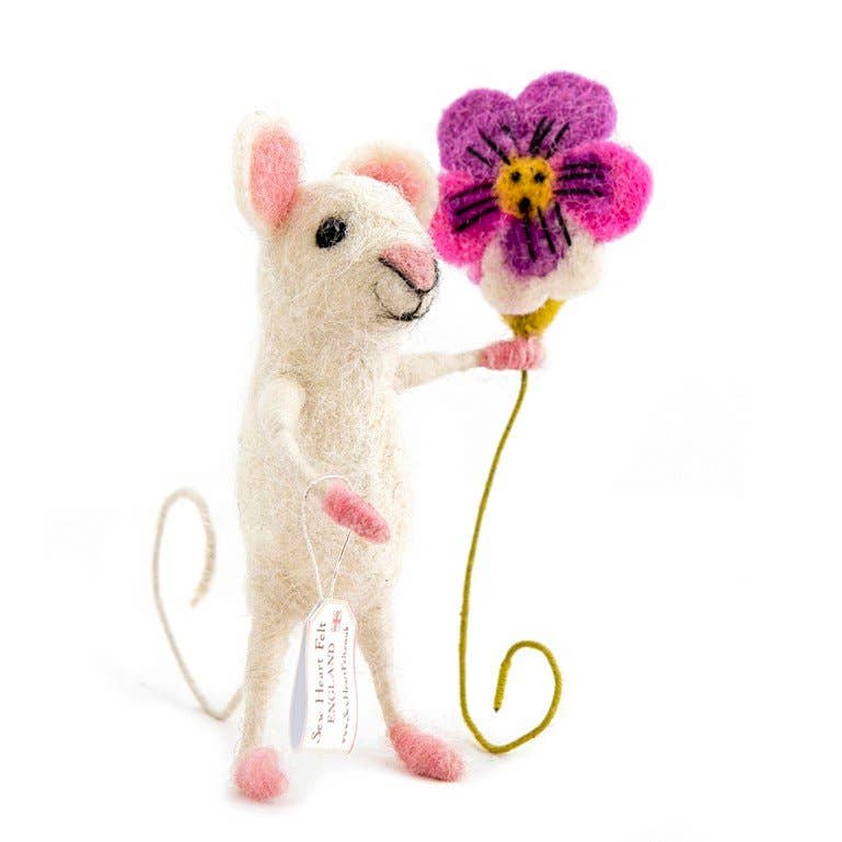 Stuffed felt mouse toy holding a pink flower on a white background