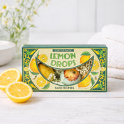 Box of Lemon Drops bath bombs with lemons on a white surface RIDER