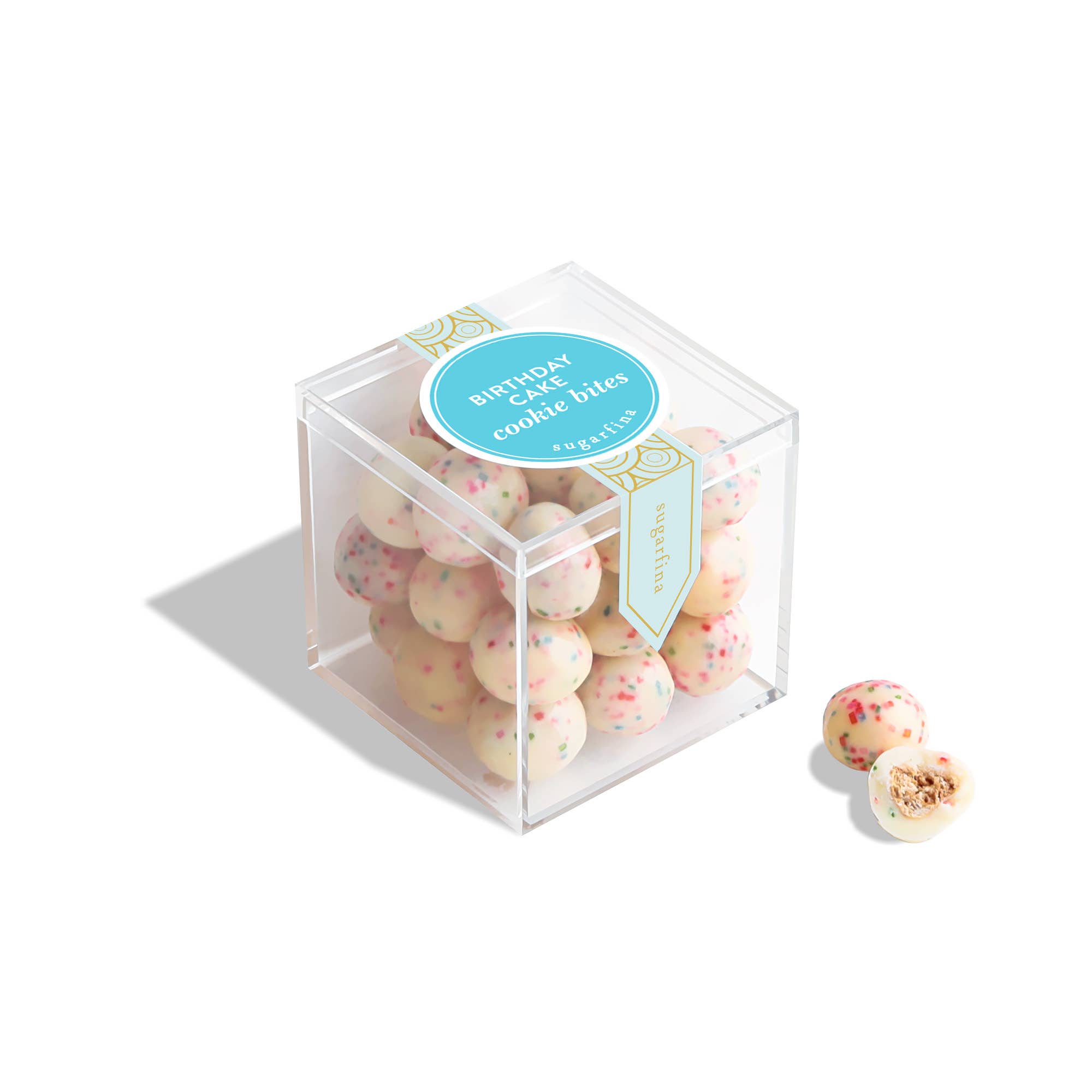 Clear cube box with cookie bites and a blue label on a white background