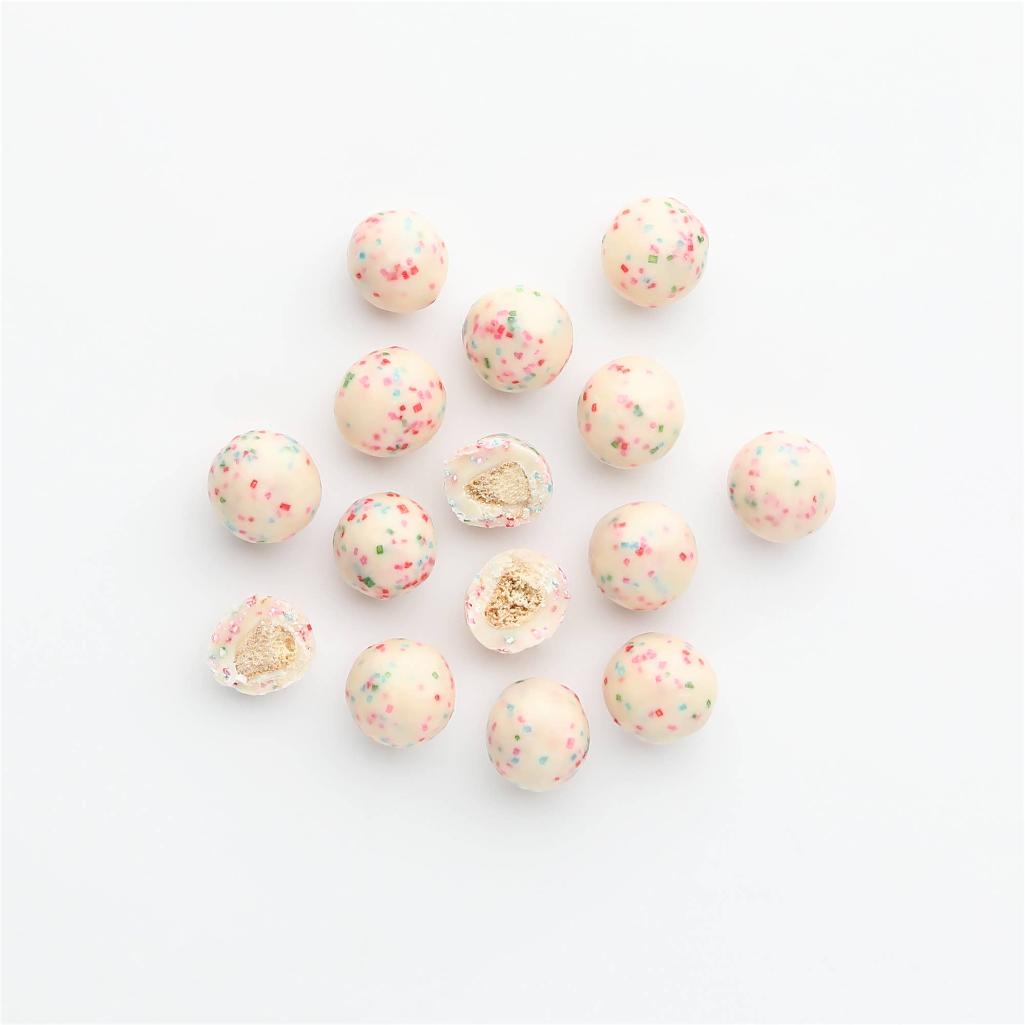 Decorative beads with gold and pink speckles on a white background
